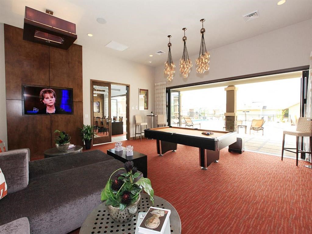 a game room with a pool table and a television