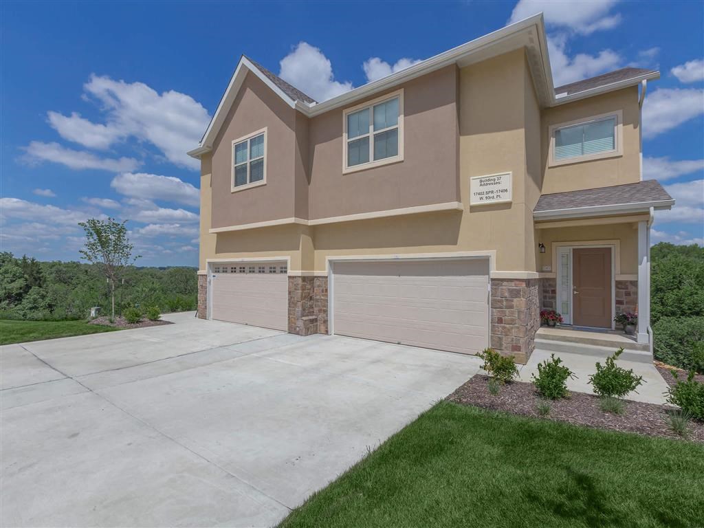 a new house with a driveway and a garage door