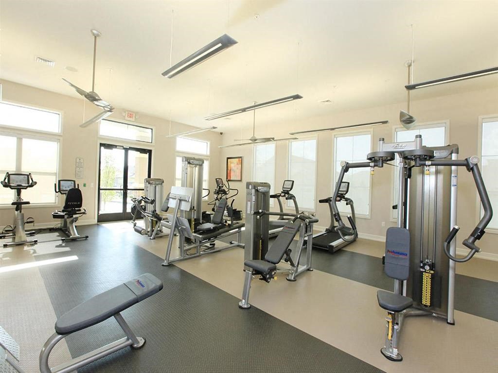 a gym with weights and other equipment in a building