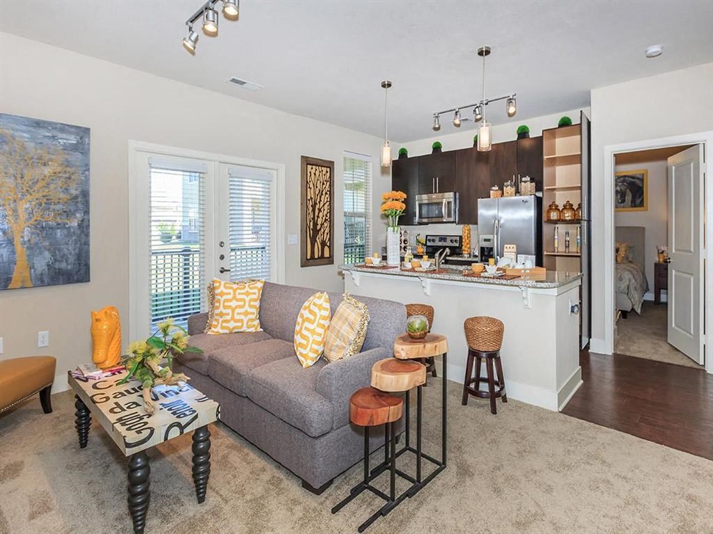 a living room and a kitchen with a couch