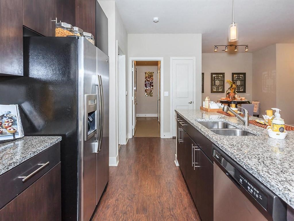 a kitchen with stainless steel appliances and granite counter tops