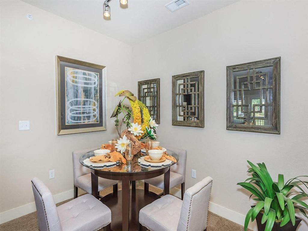 a dining room with a table and chairs