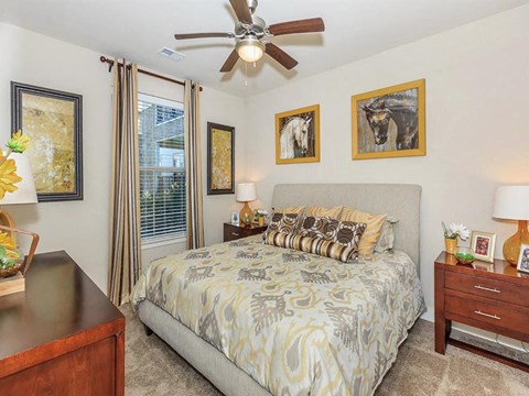 a bedroom with a bed and a ceiling fan