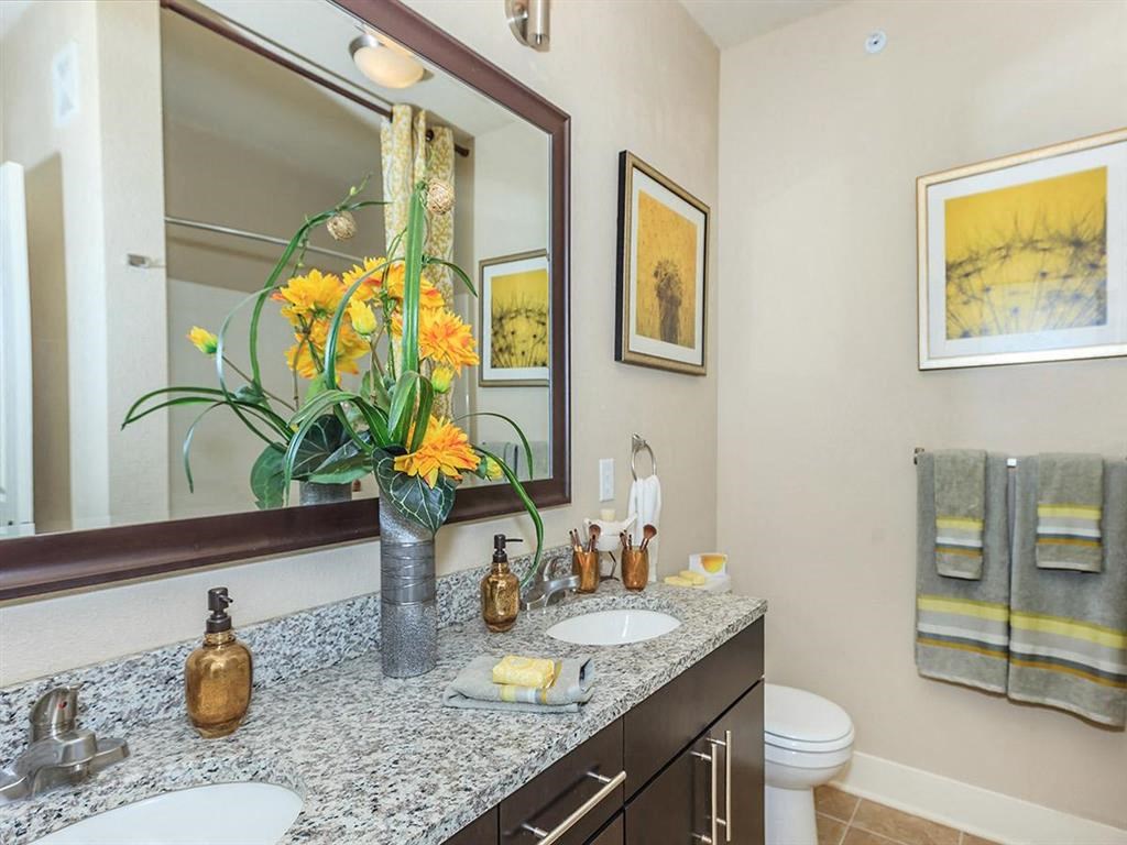 a bathroom with two sinks and a large mirror