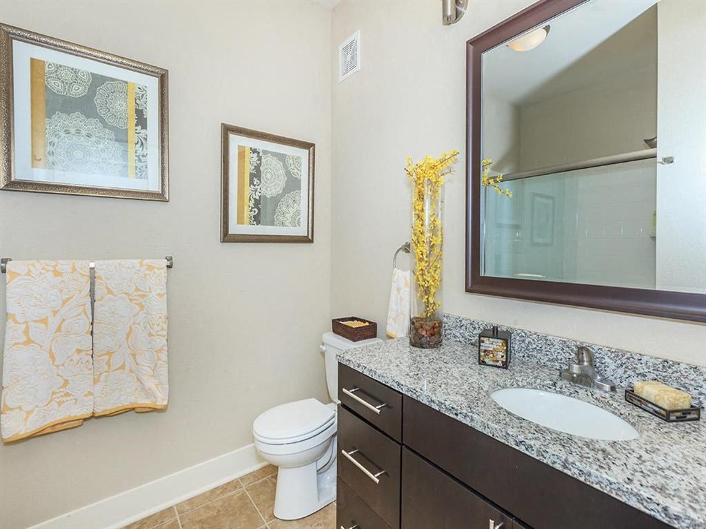 a bathroom with a sink toilet and a mirror
