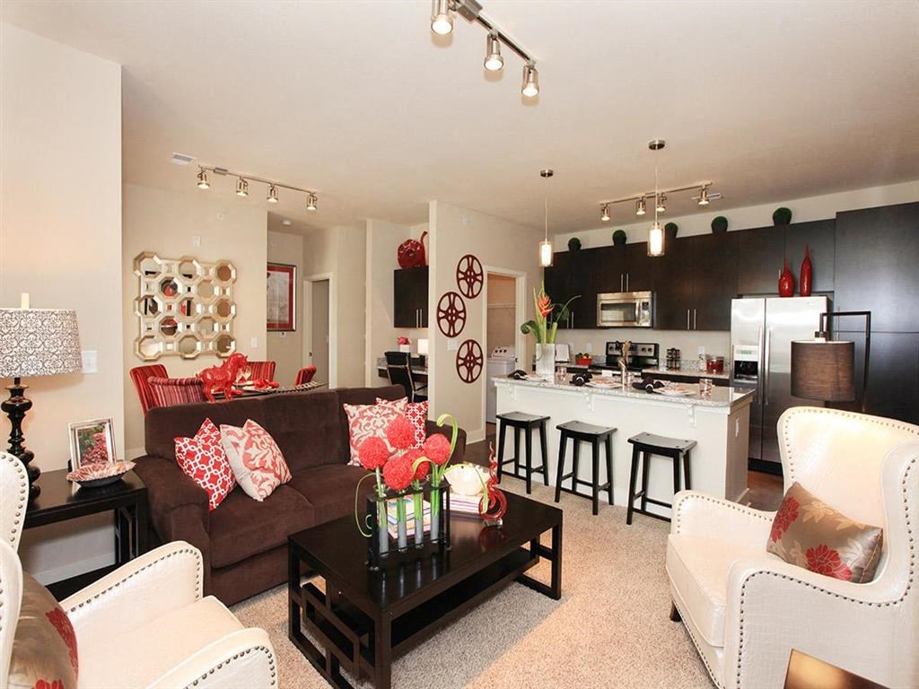 a living room and kitchen with a couch and a table