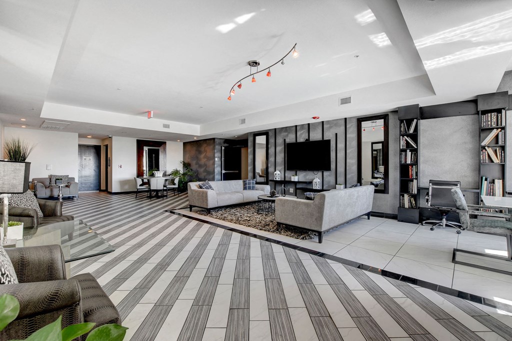 a living room with couches and chairs and a television