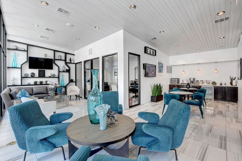 a living room with blue chairs and a table