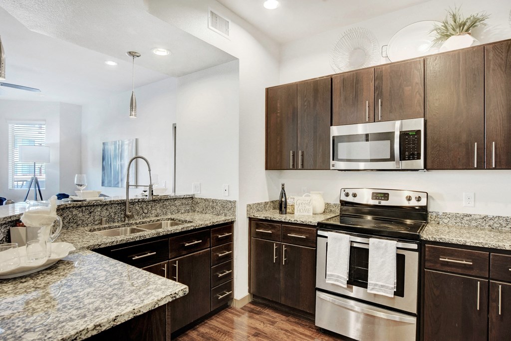 a kitchen with granite counter tops and stainless steel appliances