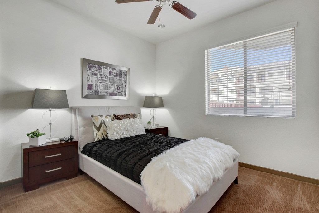 a bedroom with a bed and a ceiling fan