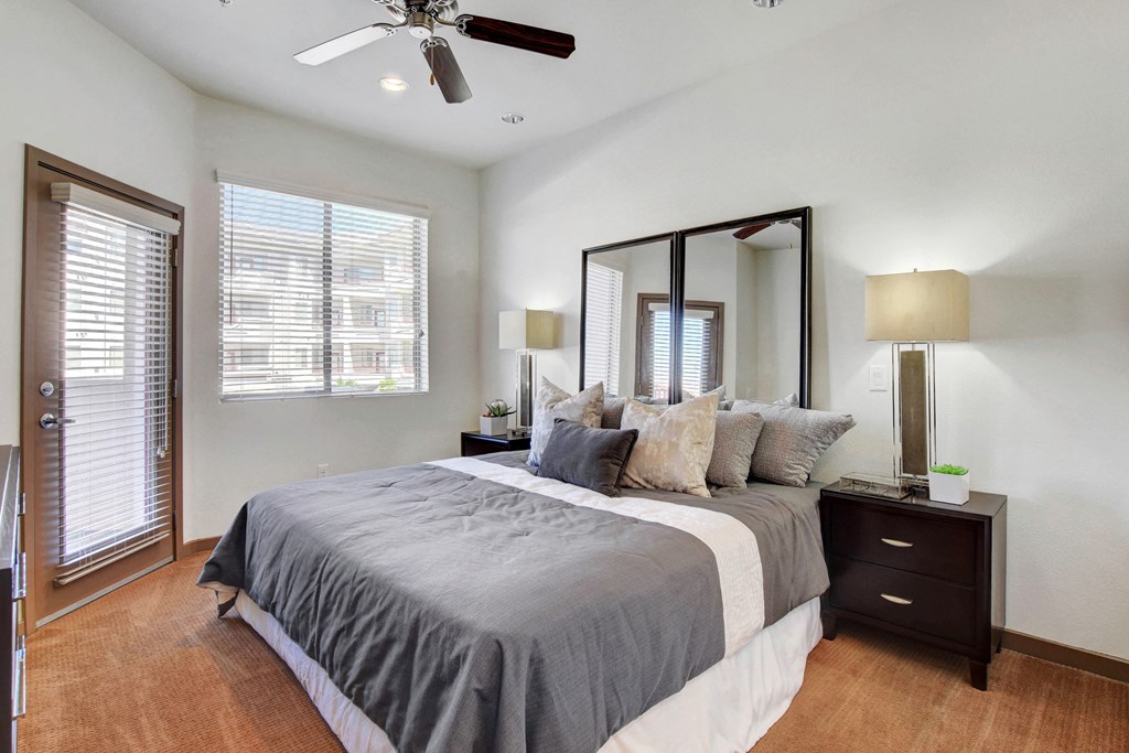 a bedroom with a large bed and a ceiling fan