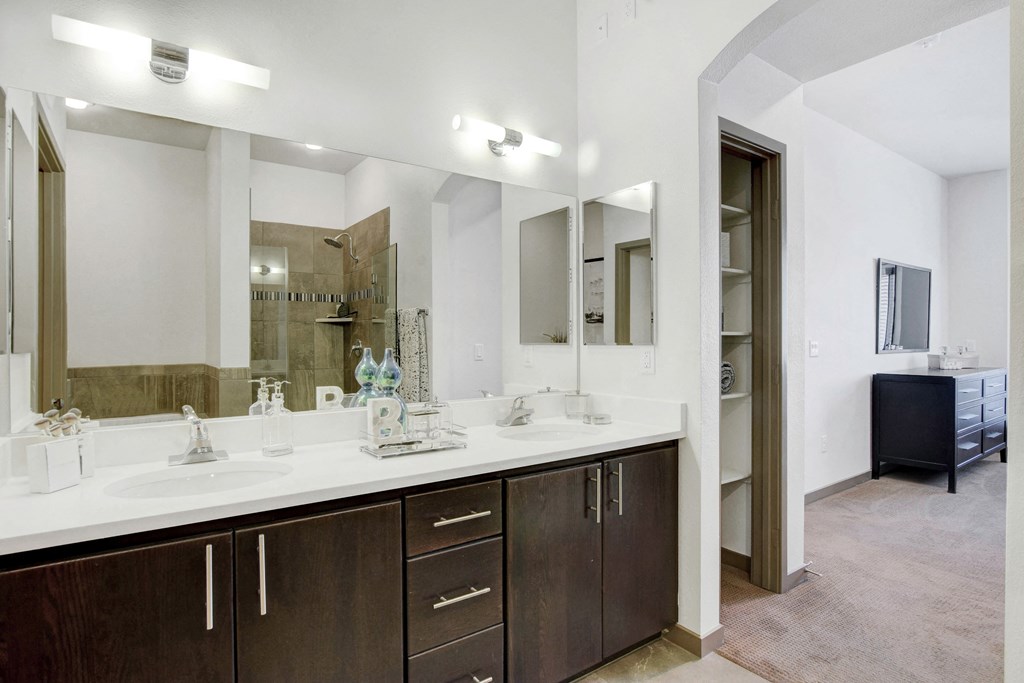 a bathroom with two sinks and a large mirror