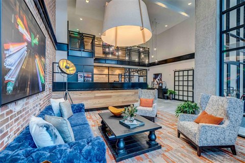 a living room with a blue couch and chairs
