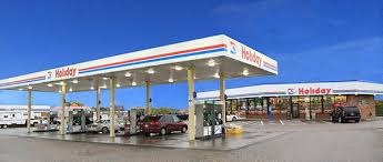 a gas station with cars parked in front of it