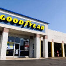The front of a Good Year store with a blue and yellow sign.