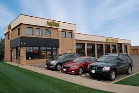 A building with cars parked in front of it.