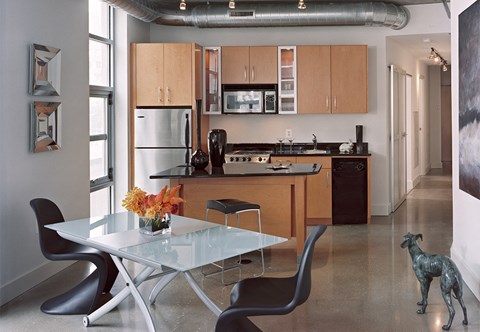 a kitchen and dining room with a table and chairs