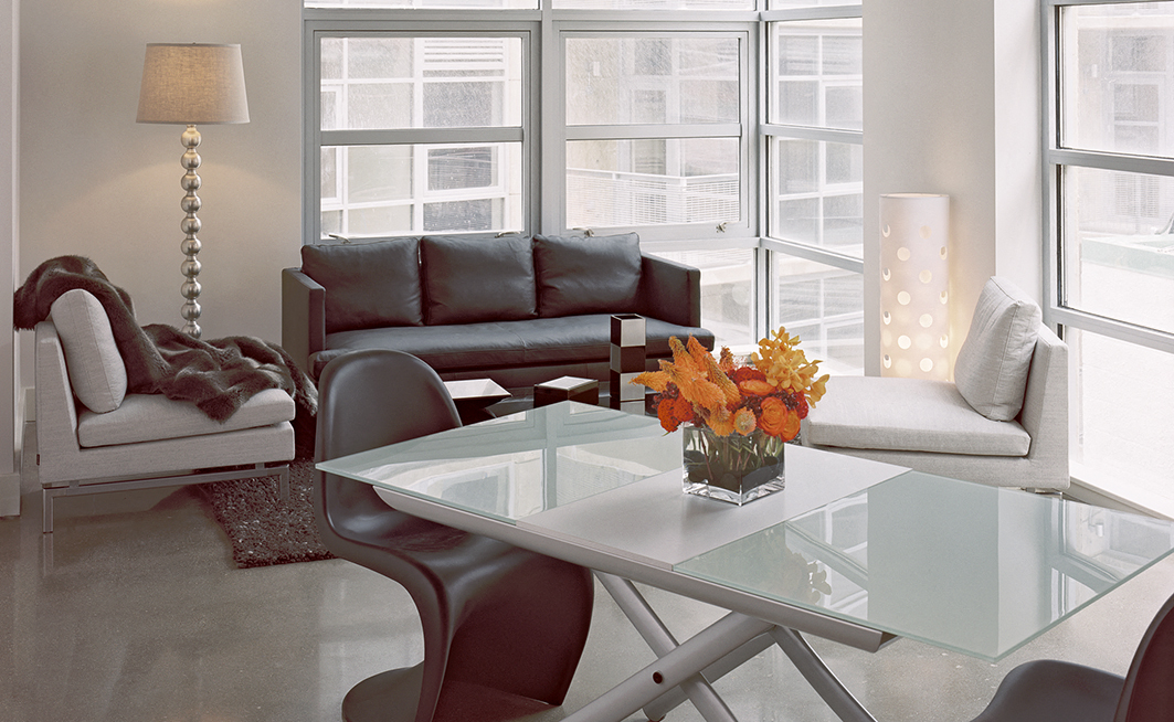 a living room with couches and a glass table
