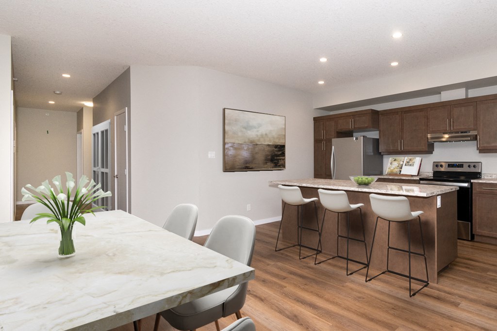 a kitchen and dining room with a marble table and chairs