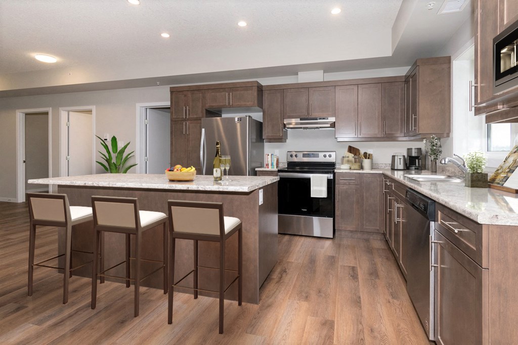 a kitchen with wooden cabinets and a large island with chairs