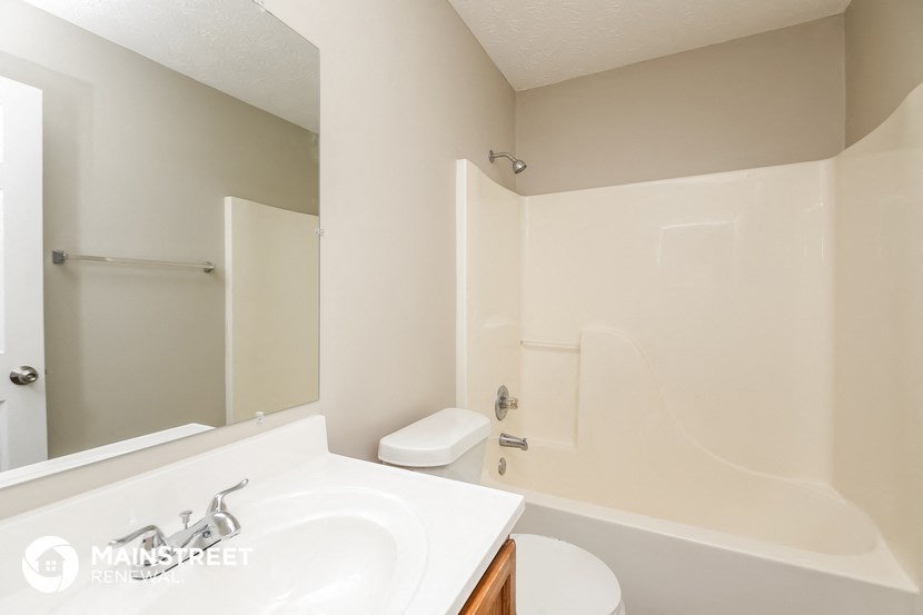 a bathroom with a sink and a toilet and a shower