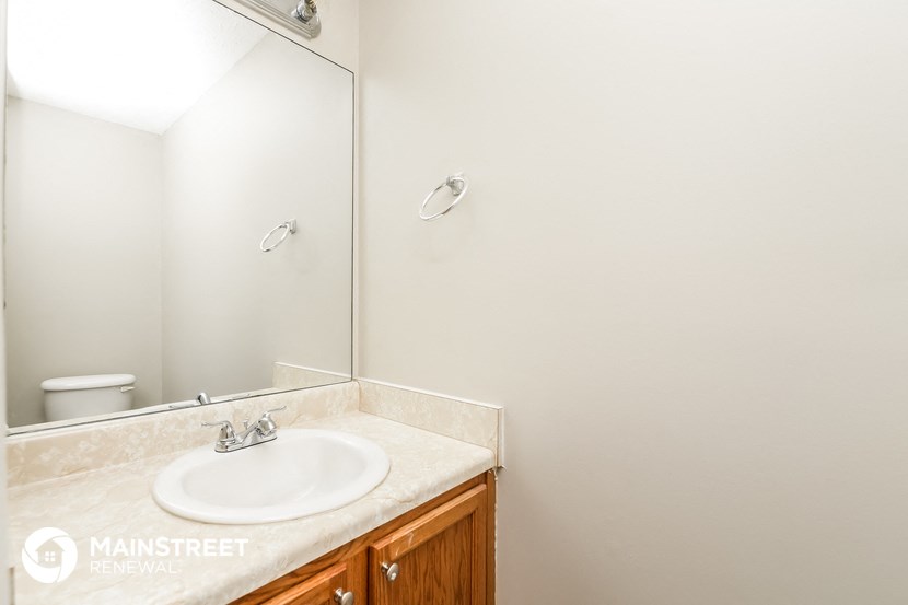 a bathroom with a sink and a mirror and a toilet