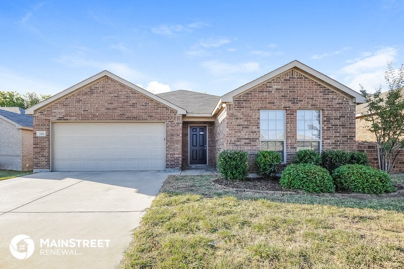a brick house with a garage and a driveway