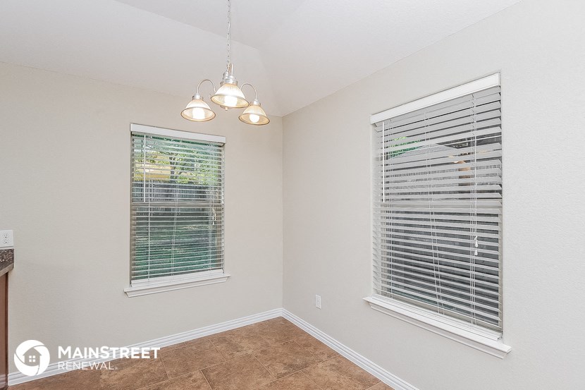 the living room of a house with two windows