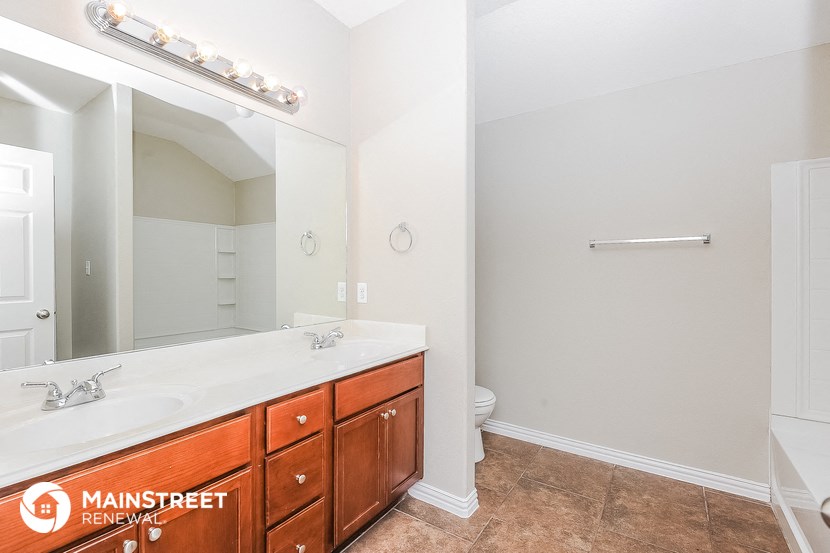 a bathroom with a sink and a mirror and a toilet