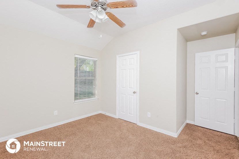 the master bedroom has a ceiling fan and two closets