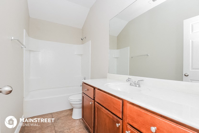 a bathroom with a sink and a toilet and a bath tub