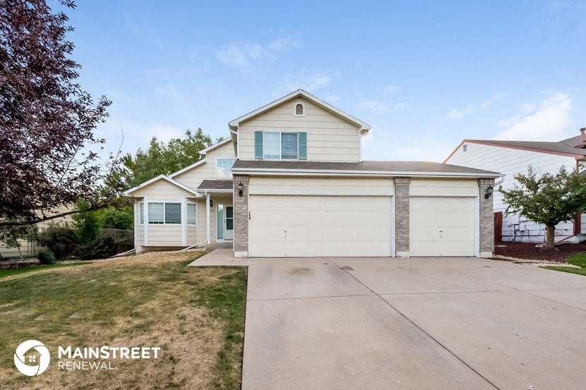 a white house with a driveway in front of it