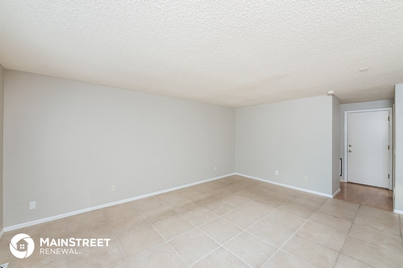 the living room and dining room of a manufactured home with tile flooring