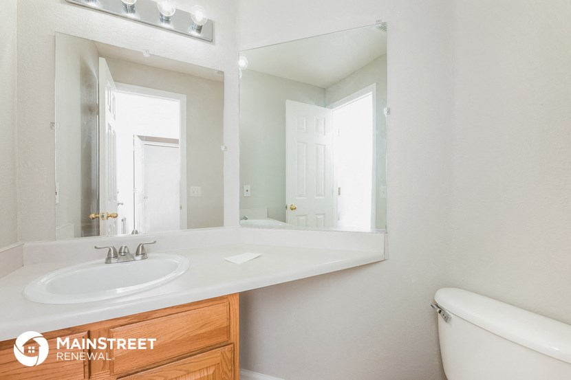 a bathroom with a sink and a mirror and a toilet
