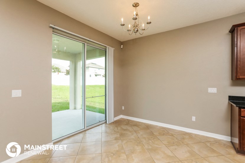 a formal living room with sliding glass doors to a patio