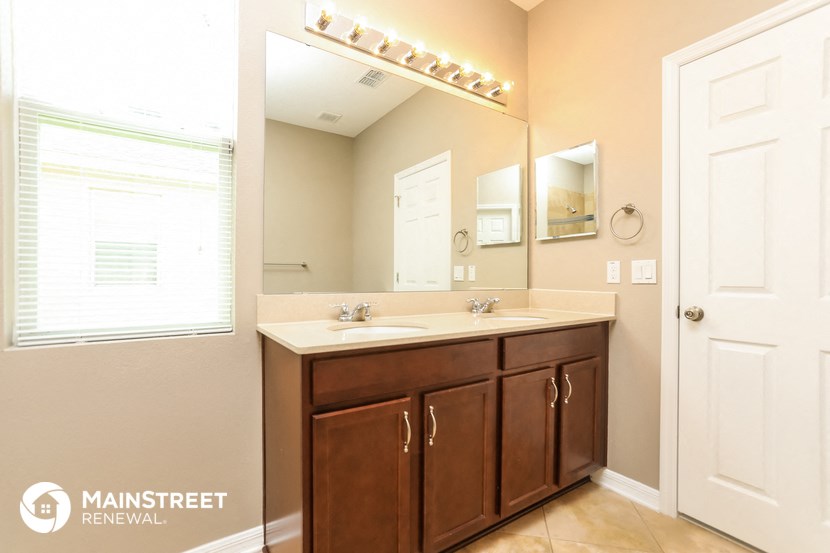 a bathroom with two sinks and a large mirror