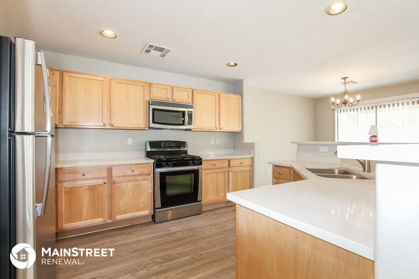 a kitchen with wooden cabinets and stainless steel appliances