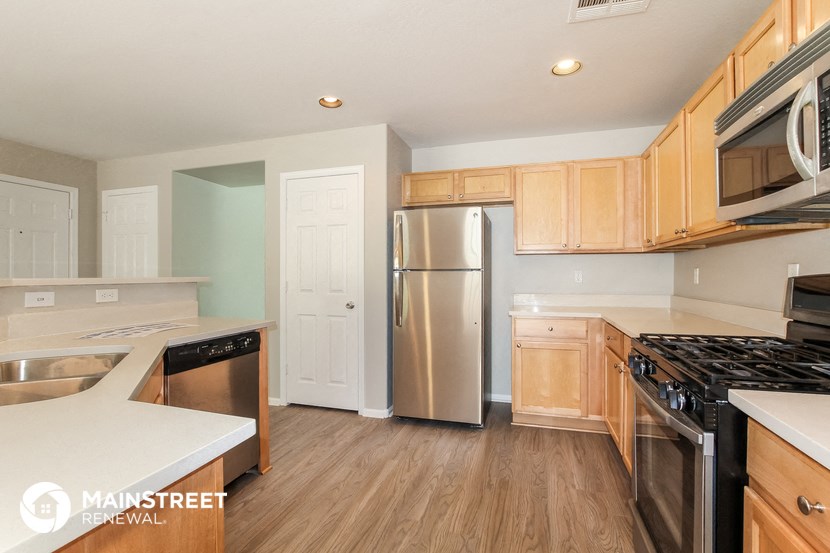 a kitchen with wooden cabinets and stainless steel appliances