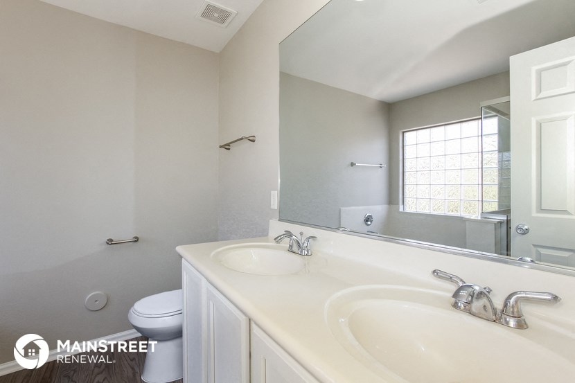 a bathroom with a sink and a mirror and a toilet