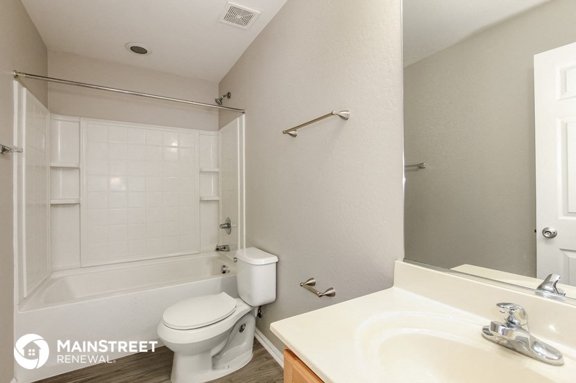 a bathroom with a shower toilet and sink and a mirror