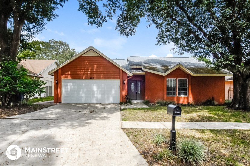 a red brick house with a white garage door