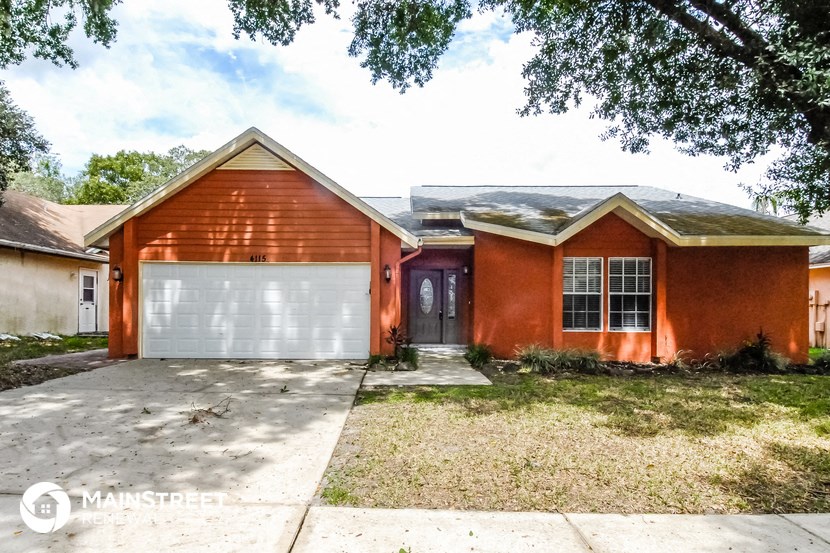 a red brick house with a white garage door