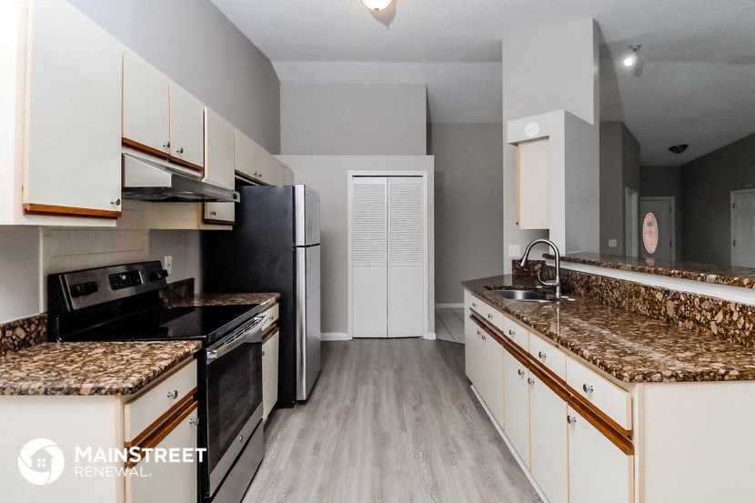 a kitchen with granite counter tops and black appliances