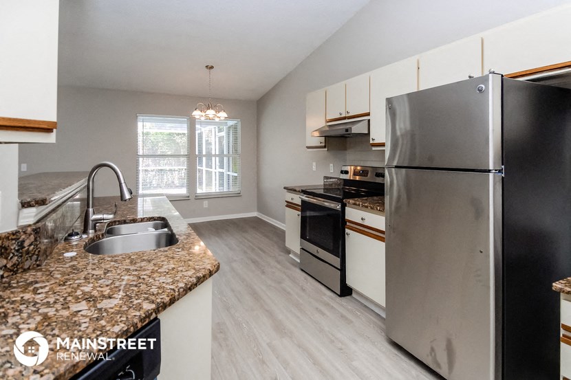 a kitchen with stainless steel appliances and granite counter tops