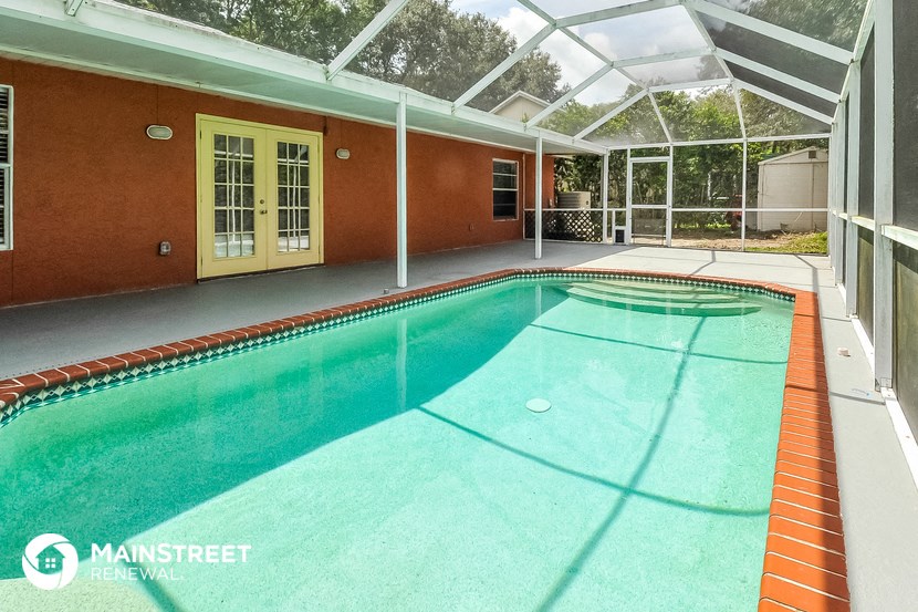 a swimming pool inside of a house with a glass roof
