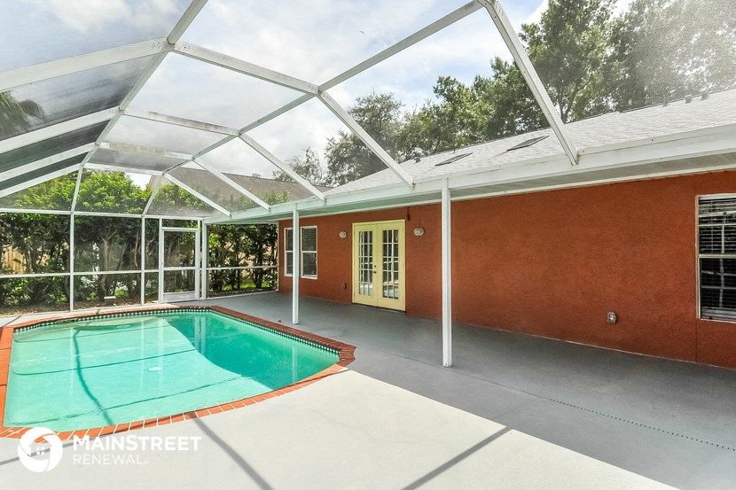 a glass roof over a swimming pool in a house
