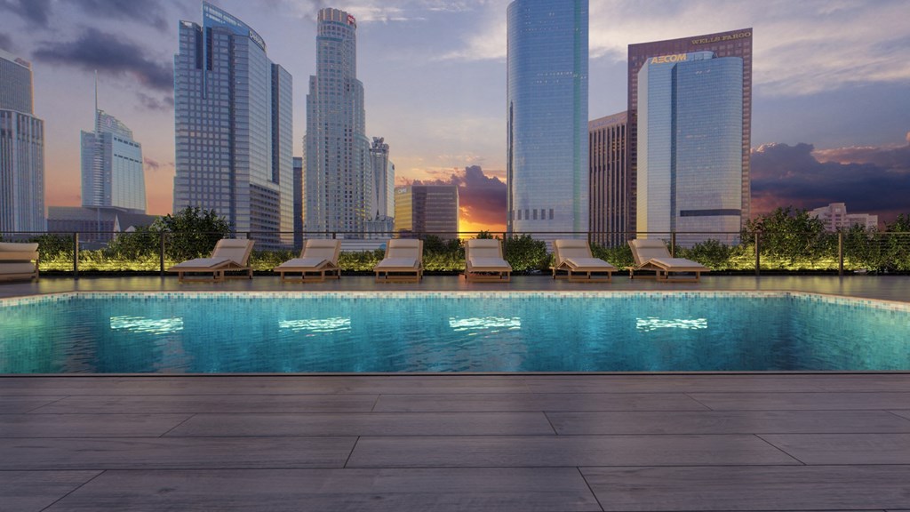 a swimming pool with a city skyline in the background