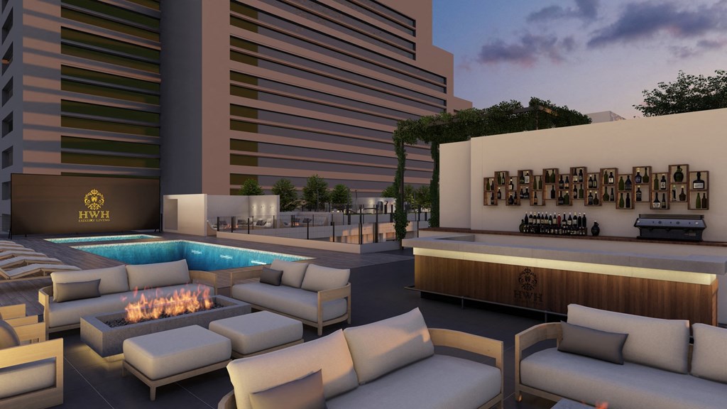 a rendering of a rooftop lounge area with couches and a fire pit