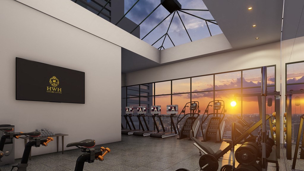 a gym with a view of the sky at sunset