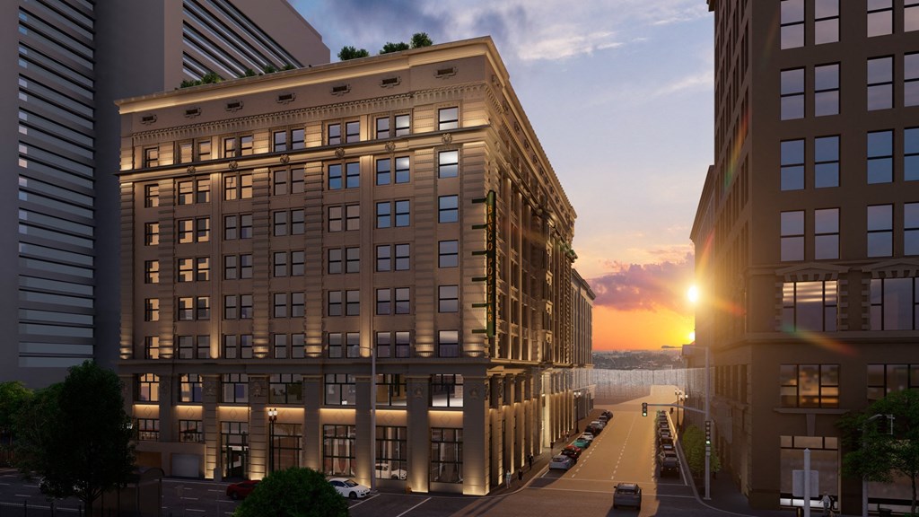 a rendering of a building on a city street at sunset